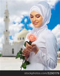 Young muslim woman with white mosque