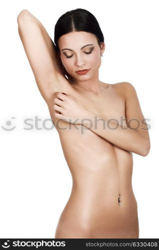 Young naked brunette woman standing on white background. Perfect epilated skin