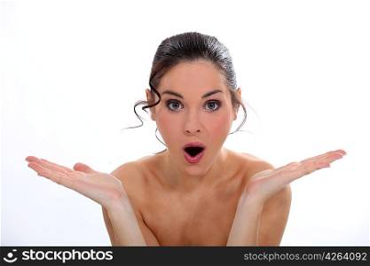 young naked woman looking surprised