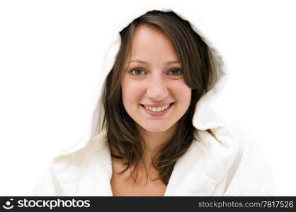 Young natural looking smiling brunette woman wearing a white bathrobe with hood on a bright background