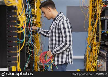 young network engineer with ethernet wires medium shot