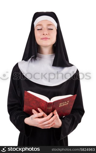 Young nun with bible isolated on white