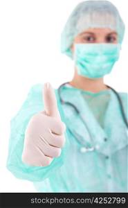 Young nurse showing thumbs up - selective focus on hand
