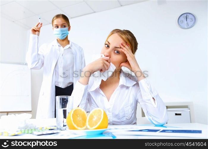 Young nurse with syringe doing vaccination in office