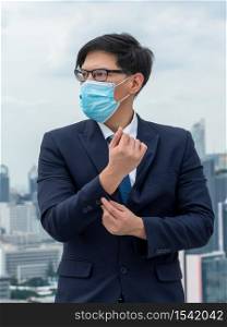 Young office worker with face mask quarantine from coronavirus or COVID-19. Concept of protective working environment to reopen business and stop spreading of coronavirus or COVID-19.
