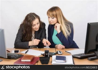 Young office workers enthusiastically discussing lipstick at your desk