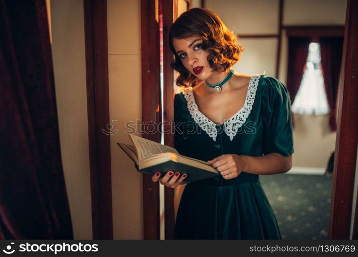 Young old-fashioned woman travels, retro train compartment. Old wagon interior. Railway journey, vintage railroad voyage. Old-fashioned woman travels, retro train