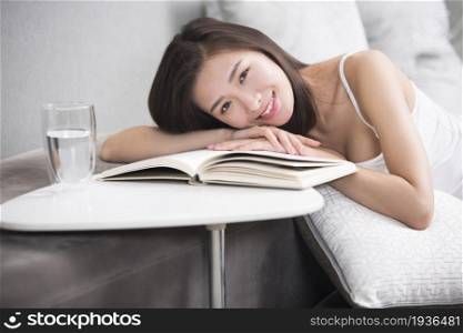 Young oriental woman reading at home