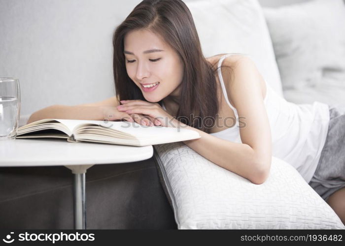 Young oriental woman reading at home