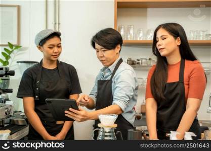 Young owner or barista wearing aprons working at the counter in coffee shop,Start up small business owner food and drink concept.