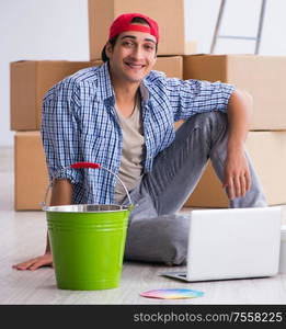 Young painter contractor choosing colors for home renovation. The young painter contractor choosing colors for home renovation