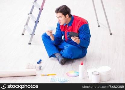 Young painter trying to match colours for painting job