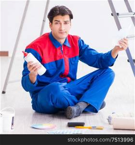 Young painter trying to match colours for painting job. The young painter trying to match colours for painting job