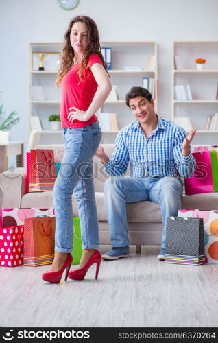 Young pair after shopping with many bags