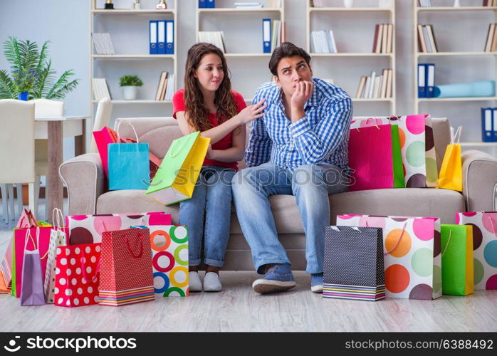 Young pair after shopping with many bags