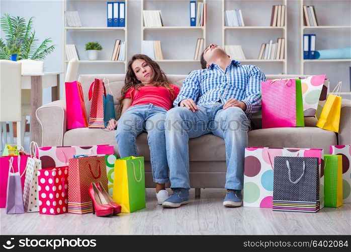 Young pair after shopping with many bags