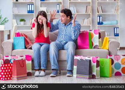 Young pair after shopping with many bags