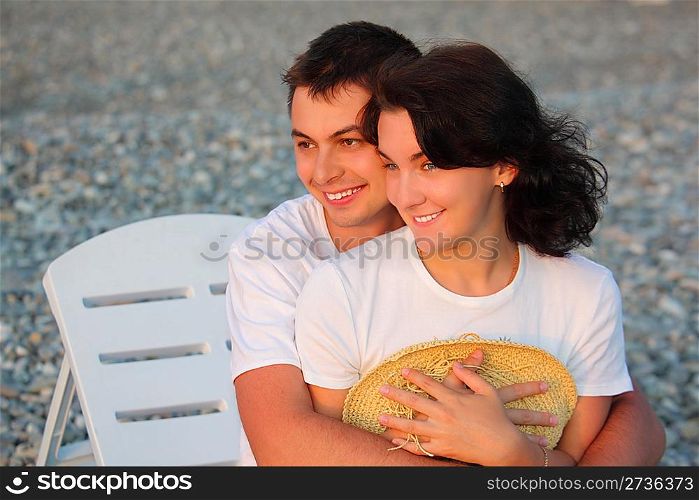 young pair embraces on beach