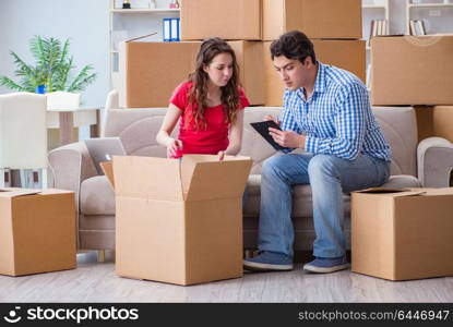 Young pair moving in to new house with boxes