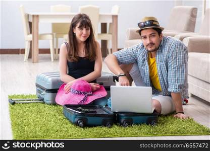 Young pair packing for summer vacation travel