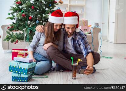 Young pair taking selfies during christmas