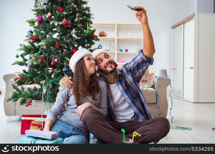 Young pair taking selfies during christmas