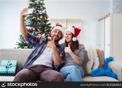 Young pair taking selfies during christmas