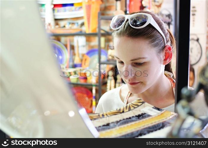 Young Pale Brunette Woman in her 20s Shopping for a Serving Plate