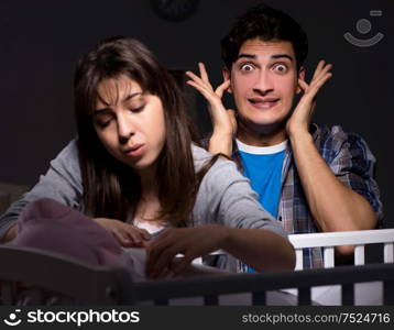 Young parents sleepless with newborn baby at night. The young parents sleepless with newborn baby at night