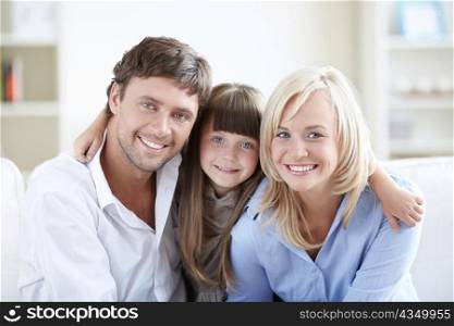 Young parents with a daughter in an apartment