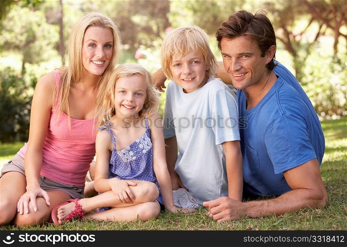 Young parents with children posing in a park