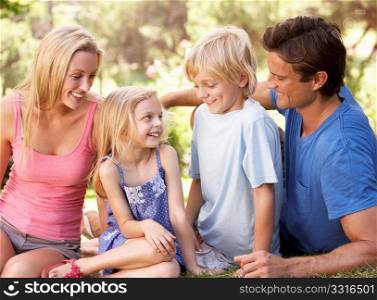 Young parents with children talking in a park