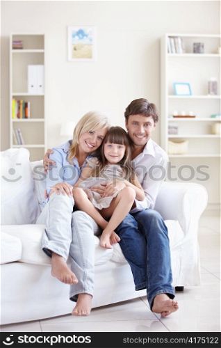 Young parents with her daughter at home
