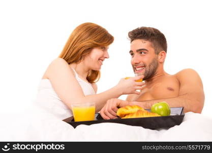 Young passionate couple having breakfast in bed