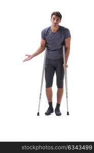 Young patient athlete sportsman suffering an injury trauma with . Young patient athlete sportsman suffering an injury trauma with crutches isolated on white