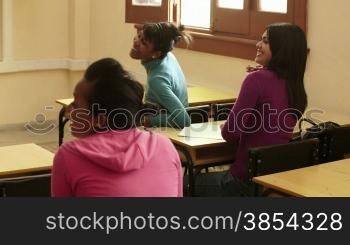 Young people and education, group of female friends talking and laughing in university class