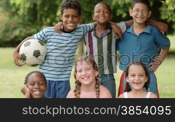 Young people and sport, portrait of six happy children with football looking at camera and smiling. Summer camp fun