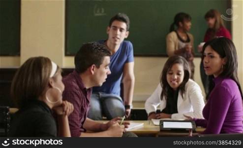 Young people at school, group of college students talking in university classroom