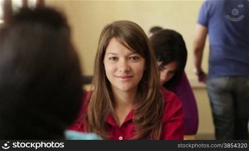 Young people at university, portrait of happy caucasian teenager smiling during test in college
