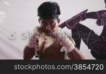 Young people, athlete, sport activities, training, gym, fitness, combat and extreme sports, asian man exercising in Yuthakun Khom, traditional khmer martial arts of Cambodia, Asia. Portrait of aggressive fighter. 10of20