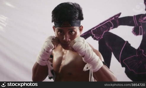 Young people, athlete, sport activities, training, gym, fitness, combat and extreme sports, asian man exercising in Yuthakun Khom, traditional khmer martial arts of Cambodia, Asia. Portrait of aggressive fighter. 10of20