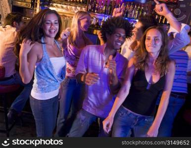 Young people dancing in a bar