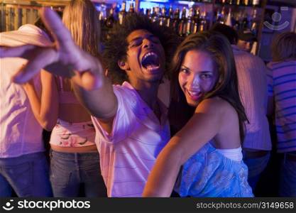 Young people dancing in a bar