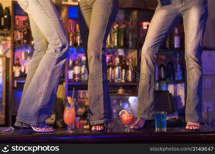 Young people dancing on a bar counter