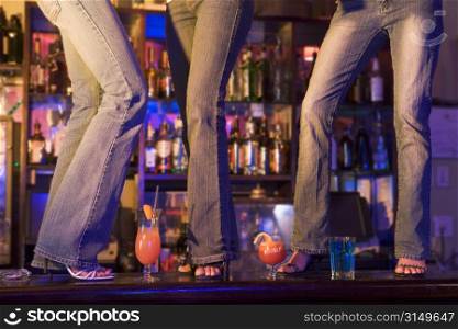 Young people dancing on a bar counter