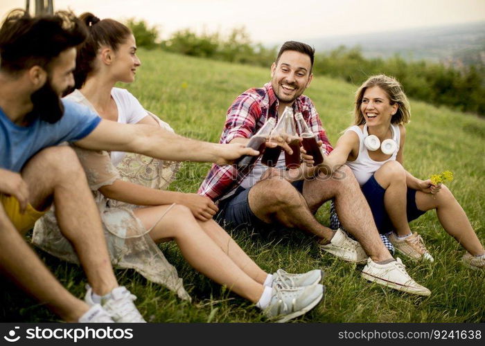 Young people drinking and having fun on a trip in nature on mountain