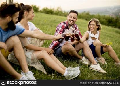Young people drinking and having fun on a trip in nature on mountain