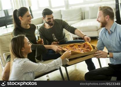 Young people eating pizza, drinking cider and have fun the room