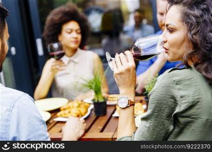 Young people enjoy the food and drink and have great fun outdoors in backyard