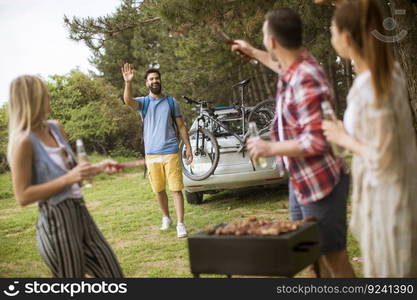 Young people enjoying barbecue party in the nature